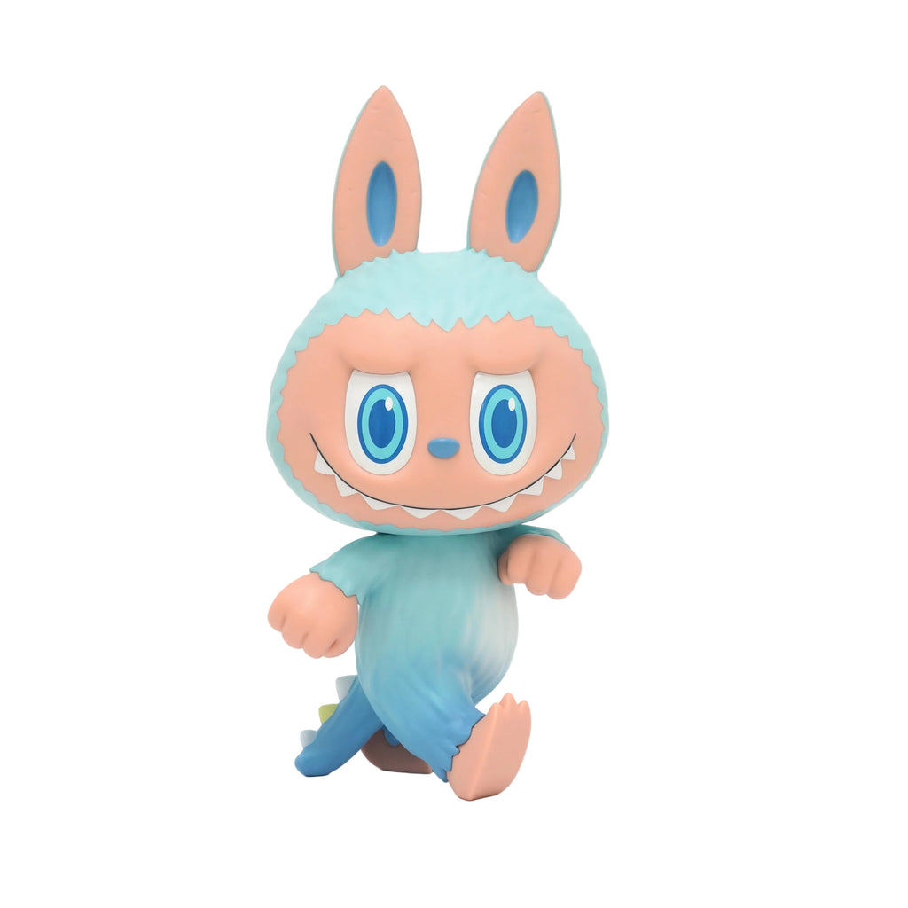 Zimomo ST — STA by How2Work is a pastel cartoon figure with large bunny ears, blue eyes, a wide grin, and a blue-to-pink gradient body, standing on two legs against a white background.