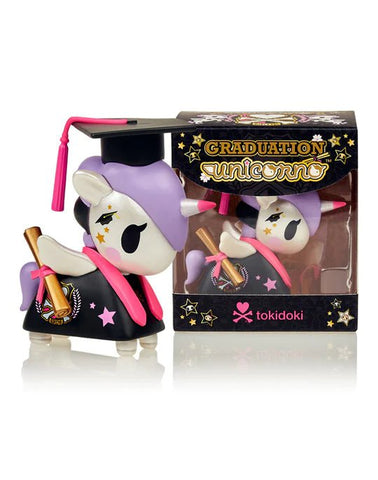 A Graduation Unicorno toy by tokidoki in a cap and gown is displayed in front of a box.