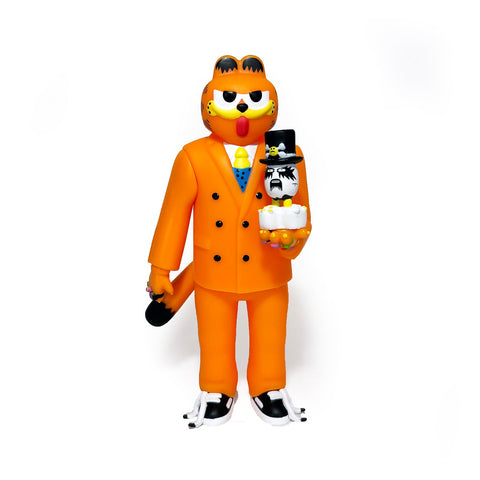 The Gangster Doodles GARF Vinyl Toy & Cassette Tape by Gangster Doodles features a cartoonish orange cat in a suit and blue tie, holding a three-tier cake with faces, standing out against a white background.