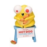 Andrew Bell’s “Hot Dog Testing Dept.” features a yellow cartoon creature with bulging eyes on a blue stool, holding two hot dogs as a pro tester, with another hot dog on the ground.
