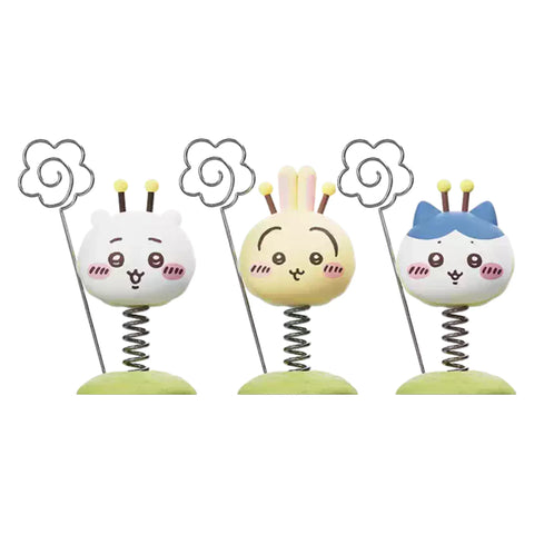 Three Chiikawa Little Bee Wobble figures on green bases, each with a metal spring wire topped with a flower-shaped note holder.