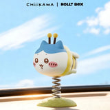 A Chiikawa Little Bee Wobble Figure of a cat-like character in a bumblebee costume, attached to a metal spring base as a desk ornament.