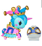 A Tokidoki Unicorno After Dark Masquerade Blind Box collectible, dressed in a jester outfit with gold accents, stands beside a blue and gold mask on a white background.