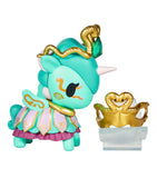 The Tokidoki Unicorno After Dark Masquerade Blind Box features a turquoise collectible figurine with gold accents, a snake-inspired headdress and crown, and comes on a clear stand—ideal for any Blind Box collection.