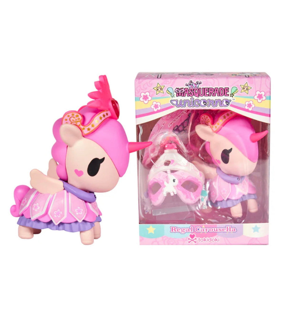 A pink and purple unicorn figurine with a mask stands by its colorful box labeled 