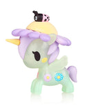 A tokidoki Flower Power Unicorno Series 2 - Daisy (Special Edition) toy figure of a green unicorn with purple mane, tail, and horn, adorned with flower decorations, with a small figure of a ladybug on its back.