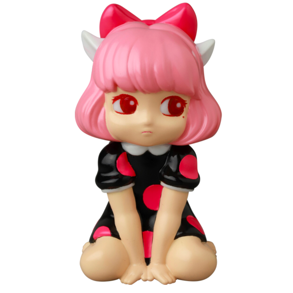 A Japanese vinyl toy, VAG 40 — Zombiecats Story Morimeiworks Nekomusume by Medicom (JP), showcases a character with pink hair, red eyes, and a pink bow. This figure wears a black dress adorned with pink dots and is posed sitting with knees bent, echoing the classic gachapon figures from Vinyl Artist Gacha collections.