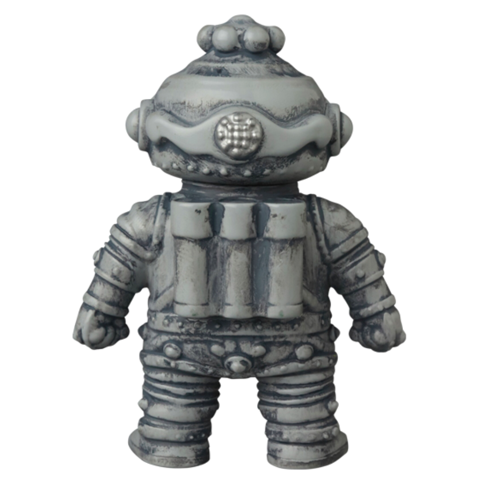 The VAG 40 — Tomodachi Zero Machine by Medicom (JP) is a vintage-style robot figure in gray and silver, reminiscent of classic Japanese vinyl toys. It features a rounded helmet and cylindrical tanks on its back, standing upright like a rare gachapon figure you'd find in nostalgic vending machines.