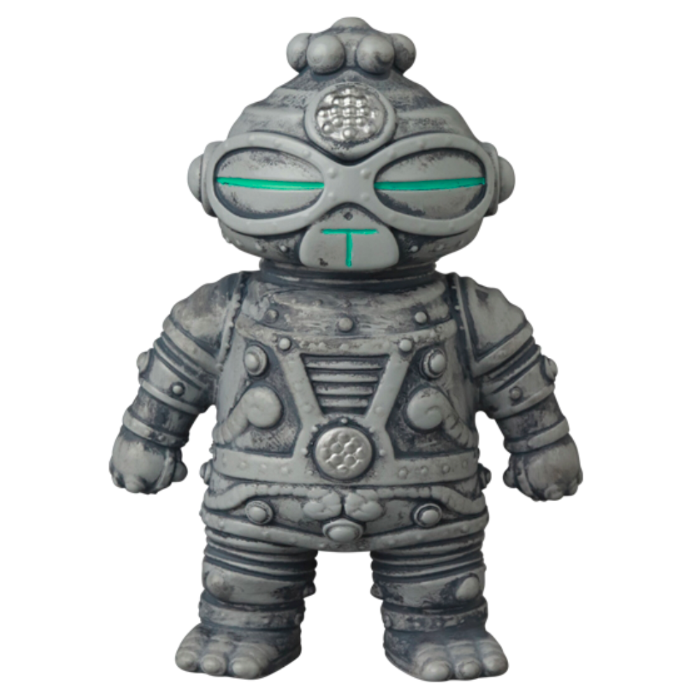 The VAG 40 — Tomodachi Zero Machine by Medicom (JP) features a gray, stylized robot figure with a textured surface and circular eyes, adorned with intricate patterns that echo the aesthetics of Japanese vinyl toys, standing proudly on a white background—an exquisite piece akin to Vinyl Artist Gacha collectibles.