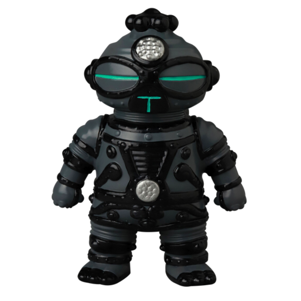 The VAG 40 — Tomodachi Zero Machine by Medicom (JP) is a gray toy robot with black accents and vivid green eyes, standing upright against a white background, reminiscent of an intricate Japanese vinyl toy from the Vinyl Artist Gacha collection.