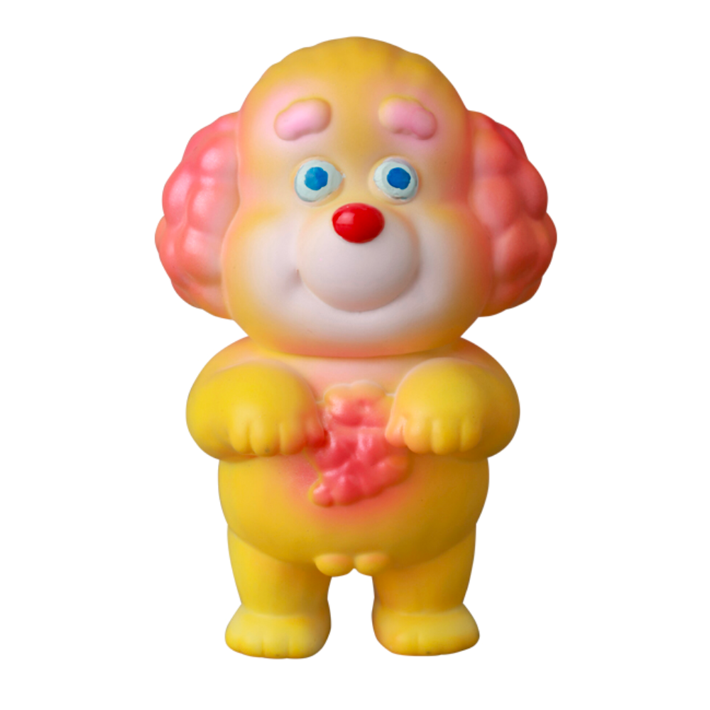 A Norakoinu Dog from Medicom's VAG 40 series, featuring pink ears and a red nose with the charm of Japanese vinyl toys, is shown holding a pink object against a white background.