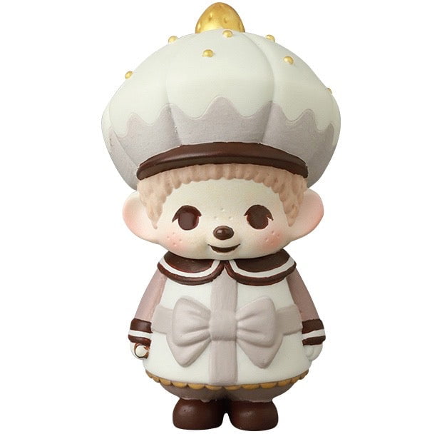 The VAG 45 — Monchhichi Happy Gift Box by Medicom (JP) is a Japanese vinyl toy featuring a character with a large white chef hat, round face, rosy cheeks, and white and brown outfit—perfect for gachapon collectors.