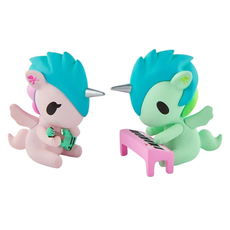 The Tokidoki Twinsies Unicorno Blind Box by tokidoki features two pastel unicorn figurines—one playing an accordion, the other a pink keyboard—perfect collectibles for any blind box fan.