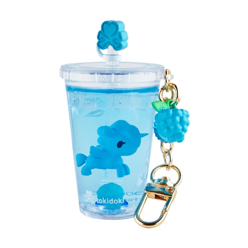 The tokidoki Beverage Besties Unicorno Blind Box keychain features a clear cup with a blue unicorn, faux ice, a blue clover lid charm, and a gold clip with blue raspberry—perfect for fans and collectors.