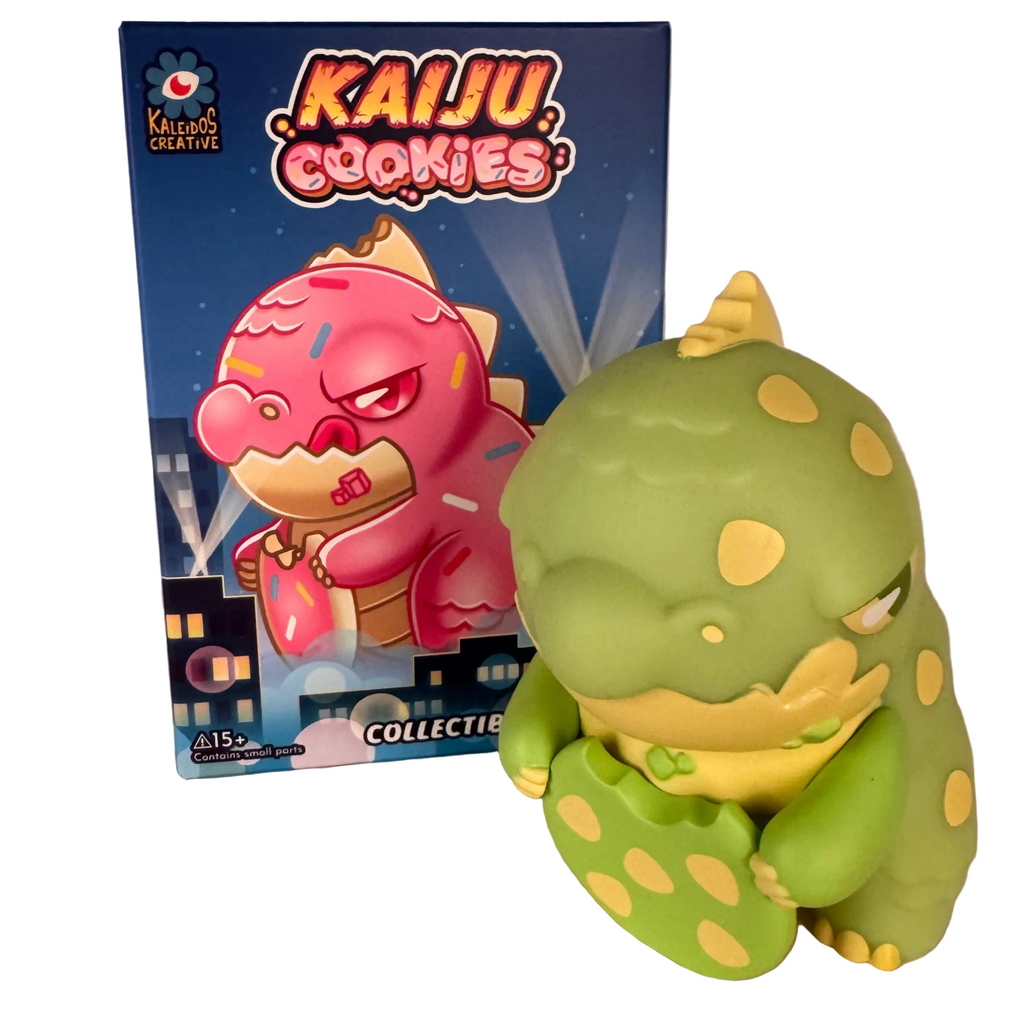 A green dinosaur figurine holding a cookie stands before its box, which features the 