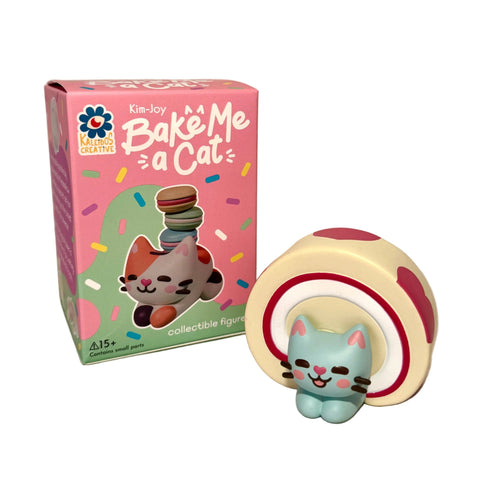 A collectible cat bakery figure from Kaleidos Creative sits beside a Bake Me A Cat Blind Box, featuring a matching cat illustration and a colorful confetti design.