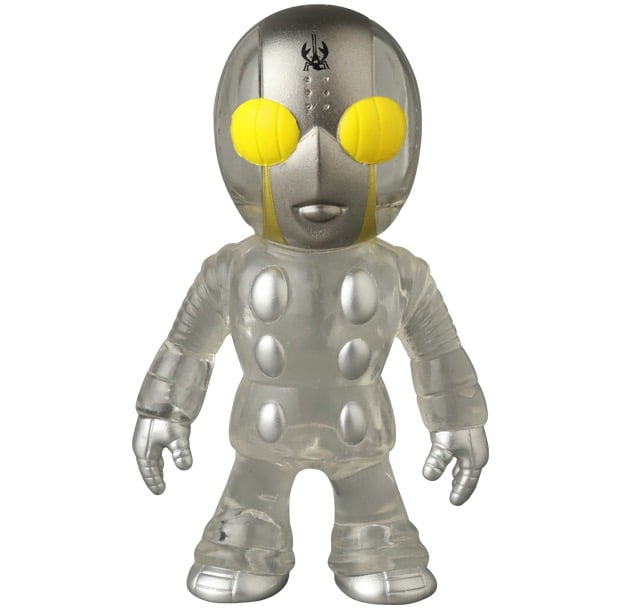 VAG 46 — Tane Man by Medicom is a small, silver and translucent Japanese vinyl toy with large yellow eyes, round body details, and a black forehead symbol—perfect for gachapon fans and Vinyl Artist Gacha collectors.