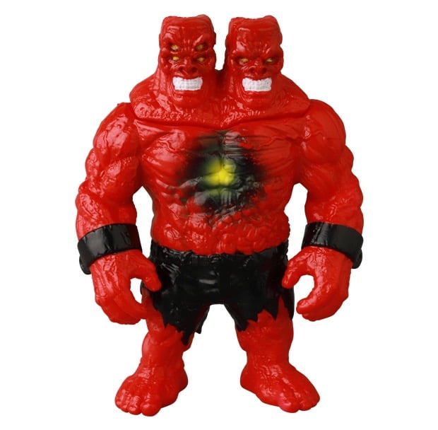 The Medicom VAG 46 — Giant Gorilla Franken Mini is a red, muscular, two-headed action figure inspired by Japanese vinyl toys, with black wristbands, torn black shorts, and a chest spot featuring a dark ring with a yellow center.
