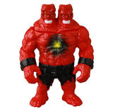 The Medicom VAG 46 — Giant Gorilla Franken Mini is a red, muscular, two-headed action figure inspired by Japanese vinyl toys, with black wristbands, torn black shorts, and a chest spot featuring a dark ring with a yellow center.