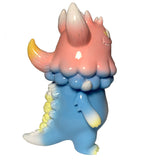 The Little Hut (HK) Rangeas Jr. - Light Blue/Pink features a pastel monster with a pink head, yellow-tipped horns and tail, and blue body, shown in profile on white—an ideal collectible for designer vinyl enthusiasts.