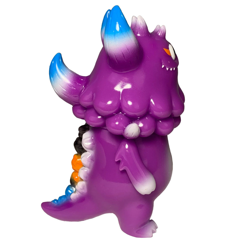 Rangeas Jr. - Purple by The Little Hut (HK) is a collectible, cartoonish monster figure with blue-tipped horns and tail, orange and white accents, an orange eye, and sharp teeth—perfect for fans of quirky designs.
