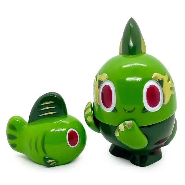 The Kibunadon Set – Green Tea by Rotofugi features two green, cartoon-style fish figures with big red eyes—one standing with arms and one lying down. Designed by Teresa Chiba, this set is a limited edition collectible.