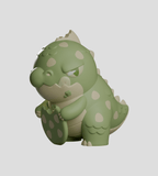 A green, cartoon-style dinosaur with beige spots sits holding a matching egg—this Kaiju Cookies Blind Box collectible from Kaleidos Creative shows off delightful charm against a simple grey background.