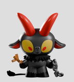 The Kid Krampus Blind Box by Kaleidos Creative features a black figurine with red horns, yellow eyes, tail, sticks, and chain on a gray background—making it a unique collectible for the holidays.
