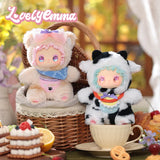 Two Lovely Emma — Pocket Zoo Blind Box plush dolls with oversized heads, one wearing a beige bear hood and the other a black-and-white cow hood, sitting in a picnic basket and a teacup.