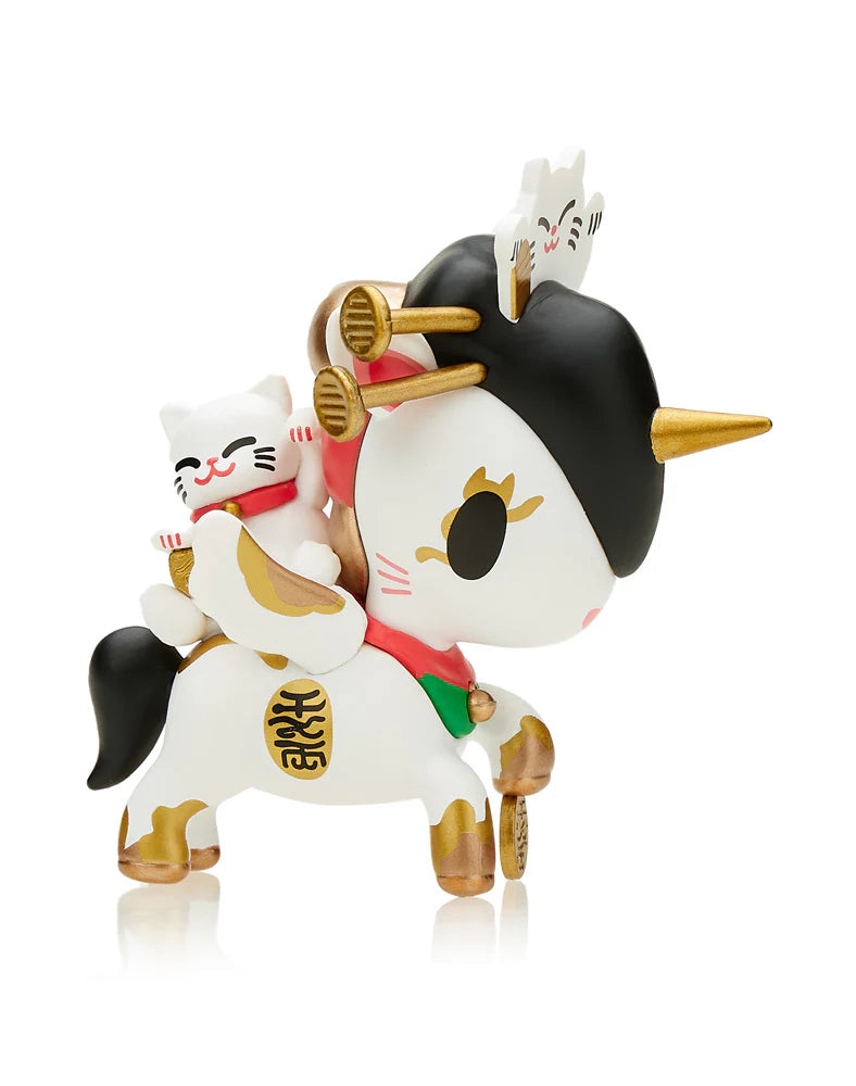 The Tokidoki Lucky Unicorno Blind Box introduces a charming figure that showcases a black mane, a shimmering gold horn, and an eye-catching red scarf, accompanied by a small white cat. Its white and gold body is gracefully highlighted with gold details. This captivating collectible might just become your next good luck charm from your Blind Box adventure.