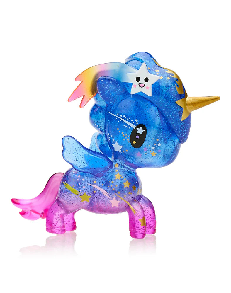 Discover the Tokidoki Lucky Unicorno Blind Box, a colorful unicorn figurine by Tokidoki. It boasts a gold horn, a blue body, pink legs, and a shimmering rainbow mane. This charming piece from the Blind Box collection is adorned with star decorations and showcases a smiling star with a rainbow trail on its forehead for good luck.