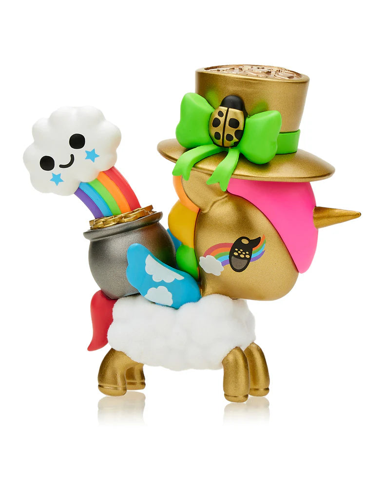 Introducing the Tokidoki Lucky Unicorno Blind Box, featuring a charming unicorn figure adorned with a gold body, pink mane, and rainbow tail, complete with a jaunty top hat. It holds a pot of gold from which a smiling cloud and rainbow emerge. Perfect for those seeking good fortune, this enchanting piece could be your next delightful find!