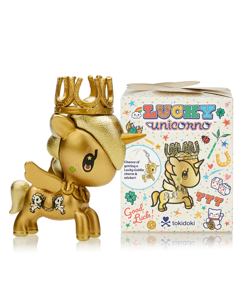 A golden unicorn figurine with a crown stands proudly next to a Tokidoki Lucky Unicorno Blind Box, featuring vibrant designs and a cartoon unicorn, promising good luck.