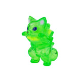 Rotofugi’s Mamera-Tropical is a small, translucent green toy figure resembling an alien cat with a spiky back, standing upright with its front paws raised.