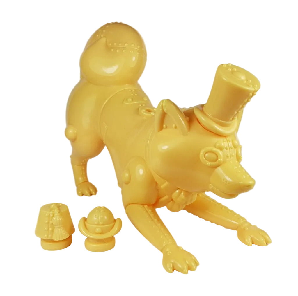 Mugi Teaworthy - Custard Cream by Lowbrowee Toys is a yellow plastic mech dog with a steampunk Victorian look, top hat, and four-leg stance. Comes with two interchangeable accessories.