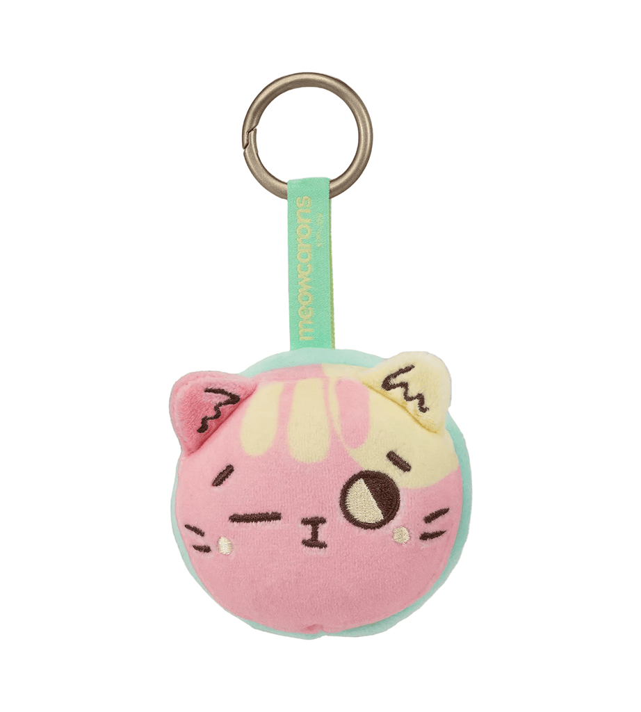 The Meowcaron Plush Bag Charm by Kaleidos Creative is a round cat face keychain in pink, yellow, and cream with a winking expression—an adorable bag companion with a teal fabric loop and keyring.