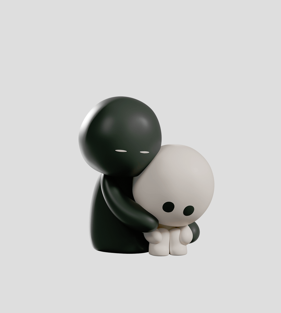 A matte black Meyanmi Shadow Blind Box figure by Kaleidos Creative hugs a smaller, matte white figure sitting with knees up, both displayed against a plain gray background.
