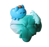 The Rotofugi National Palace Museum Adventure-Bugcat Capoo Figurine features a blue cartoon cat with a brown stripe atop green leaves, facing a light blue bug—ideal for blind box fans and collectors.