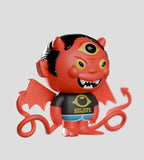 A red, three-eyed devil figurine with horns, wings, a tail, and a 