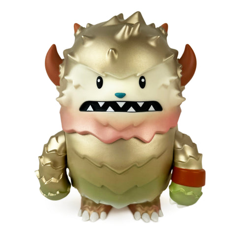 A gold and beige Lucas — Forest Adventure toy monster figurine from The Little Hut (HK), featuring horns, sharp teeth, and a spiky texture, is set against a white background.