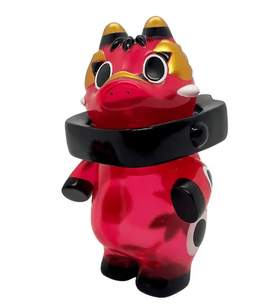 Rotofugi's Akabegon - Clear Red is a shiny red and black cartoon figurine with large eyes, gold accents, and a thick black collar—a playful good luck charm inspired by Akabeko and reminiscent of Teresa Chiba’s iconic designs.