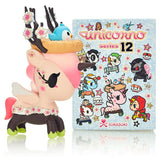 A tokidoki Unicorno Series 12 Blind Box with a unicorn figurine and characters book.