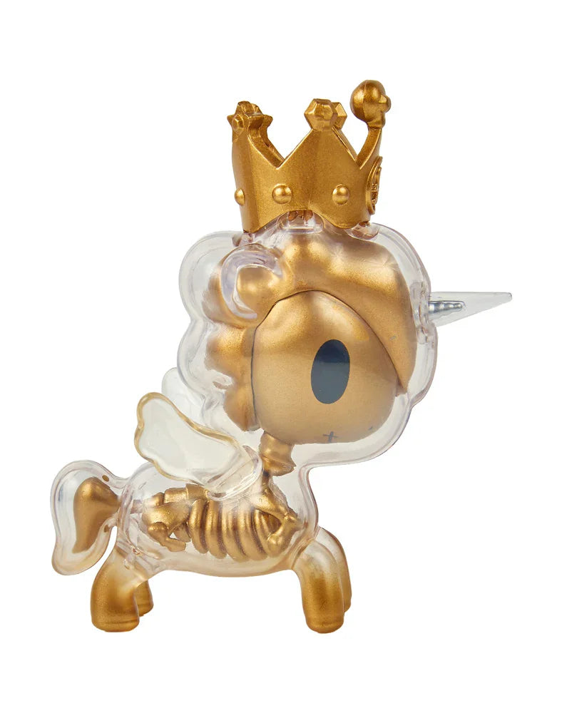A small After Dark Skeleton Unicorno Blind Box figurine by tokidoki, featuring a gold and clear design with a crown, visible ribs, wings, and a silver horn—viewed from the side and perfect for any blind box collector.