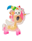 Discover whimsical surprises in the tokidoki After Dark Skeleton Unicorno Blind Box, featuring a small, clear plastic unicorn toy with pink legs, a gold body, wings, and a colorful mane decorated with playful details like a skull, ice cream, and rainbow horn.