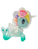 Introducing the After Dark Skeleton Unicorno Blind Box by tokidoki—a translucent toy figure with a turquoise tail, pearl necklace, clear mane, yellow hair, and a pink seashell headpiece reminiscent of a mermaid unicorn—perfect for any Blind Box collector.