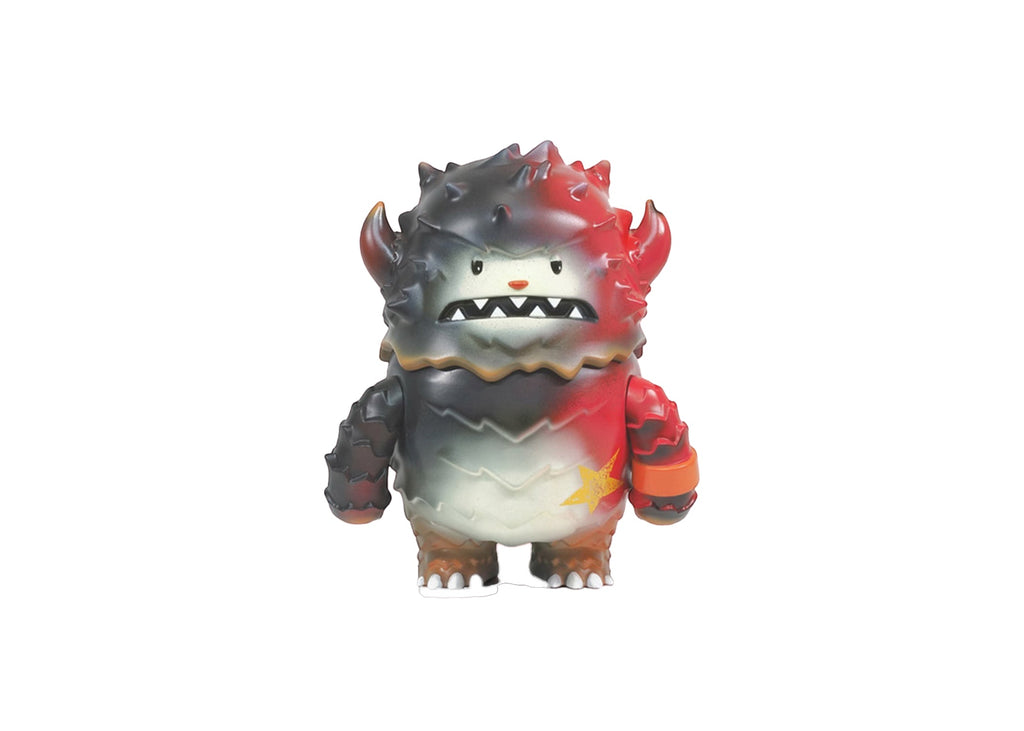The Lucas-Starbeast Adventure vinyl toy by Rotofugi features a spiky, monster-like design with red and black gradient colors, sharp teeth, and a yellow star on its chest, displayed on a white background.