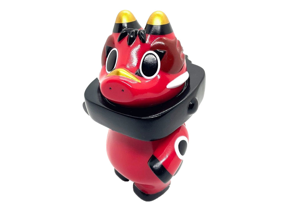 The Akabegon- Red by Rotofugi is a red, cartoon-style vinyl figure with big eyes, yellow-tipped horns, and a black collar, inspired by the Akabeko legend and shown upright on a white background.
