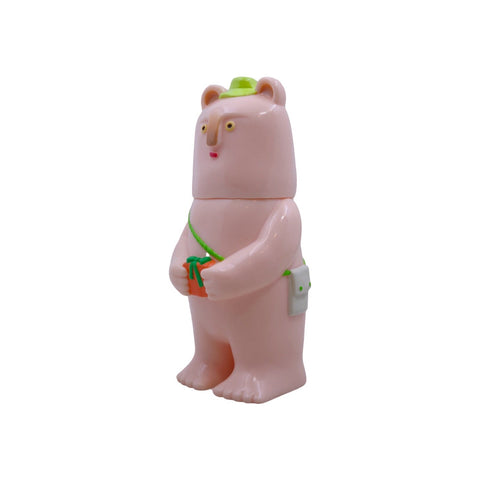 The Rotofugi Kurichan - #5 is a pink bear with a green hat and bag, holding a small green-wrapped gift—an embodiment of eternal cuteness photographed on a plain white background.