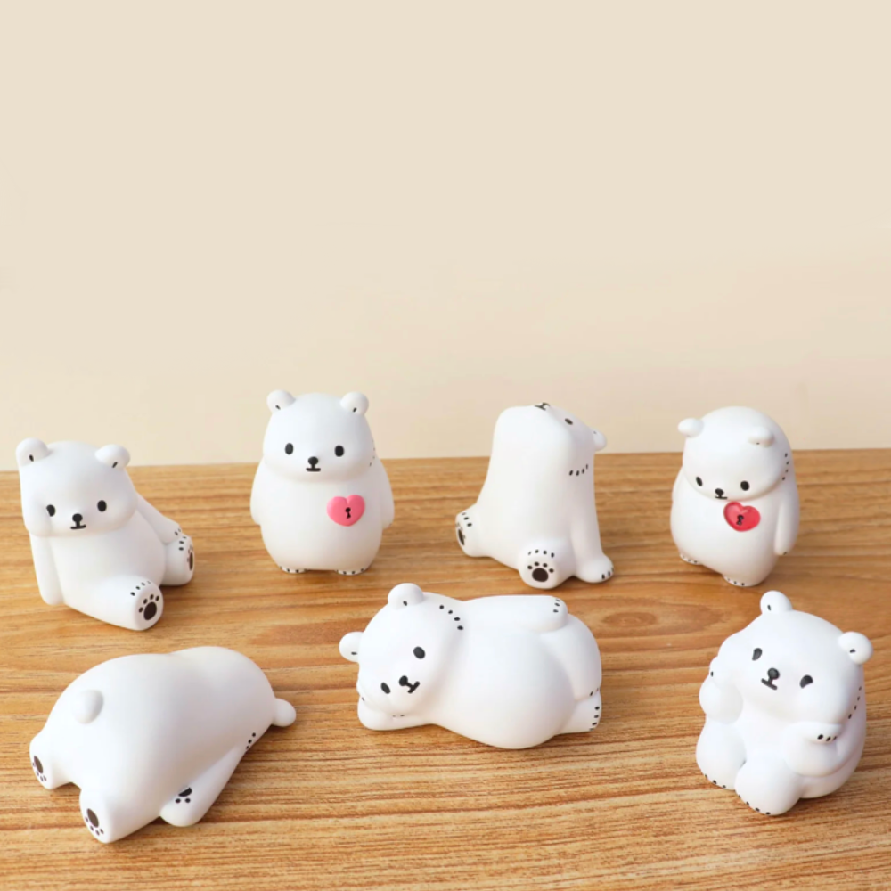 Seven Bac Bac is Thinking About (Polar Bear) Blind Box figurines by Partner Toys (TW) are arranged on a wooden surface against a beige background, each in different poses. Some hold pink hearts, reminiscent of lonely hearts yearning for companionship.