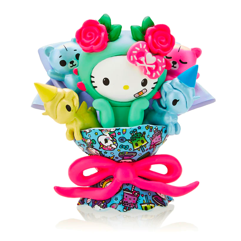 The tokidoki x Hello Kitty 50th Birthday - Bouquet (Special Edition) features an adorable tokidoki cartoon figure dressed in a green costume adorned with a pink bow and flowers, accompanied by small animal figures, all nestled in a vibrant holder tied with a large pink ribbon. This Birthday Special Edition is perfect for Hello Kitty fans!